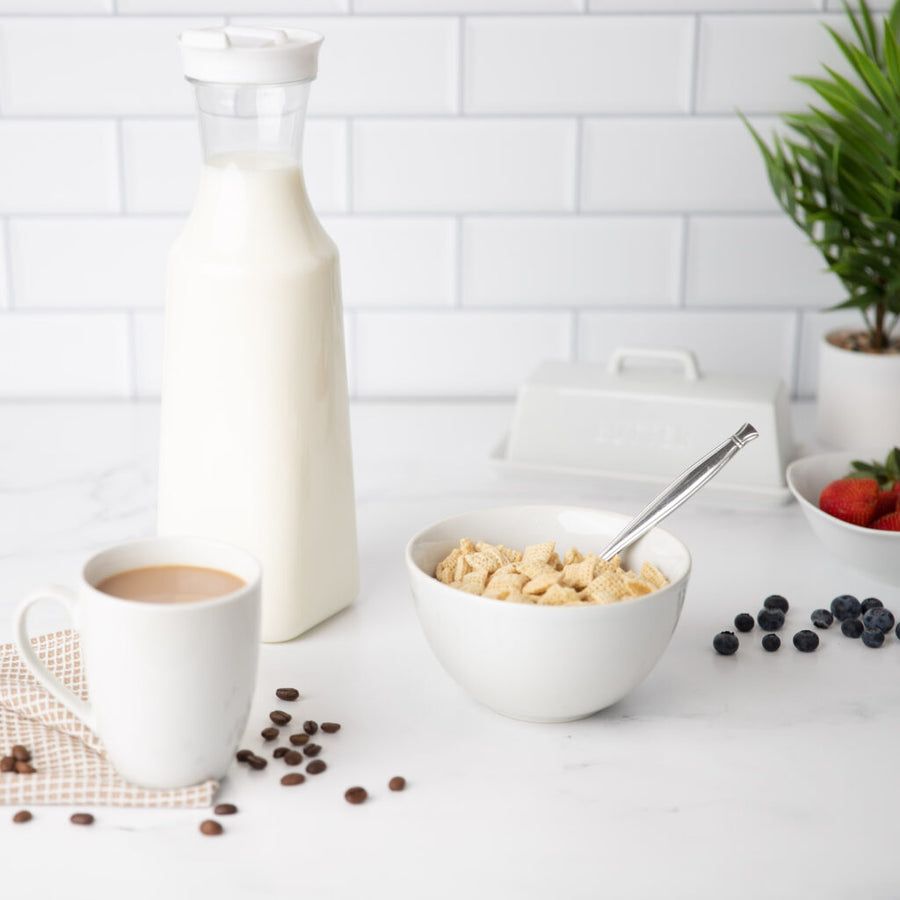 Square Pitcher With White Lid 54 oz filled with milk on a breakfast counter - The Closeout Connection