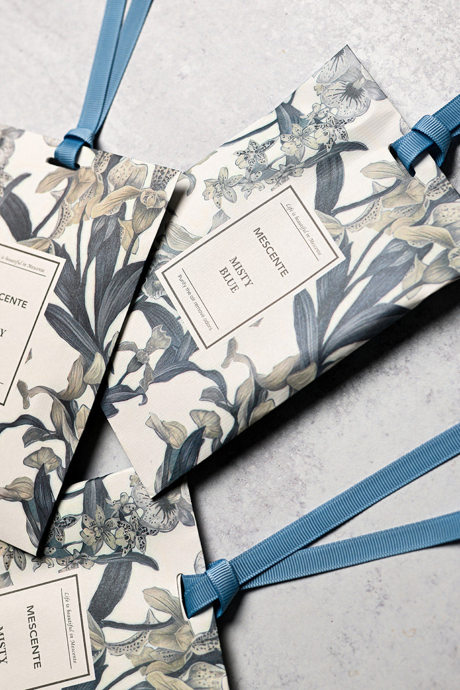 Mescente Misty Blue scented sachets close up with blue ribbons