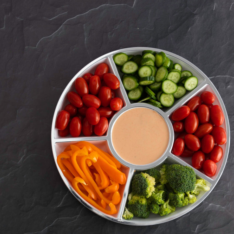 White 6 section round tray filled with vegetables and dip