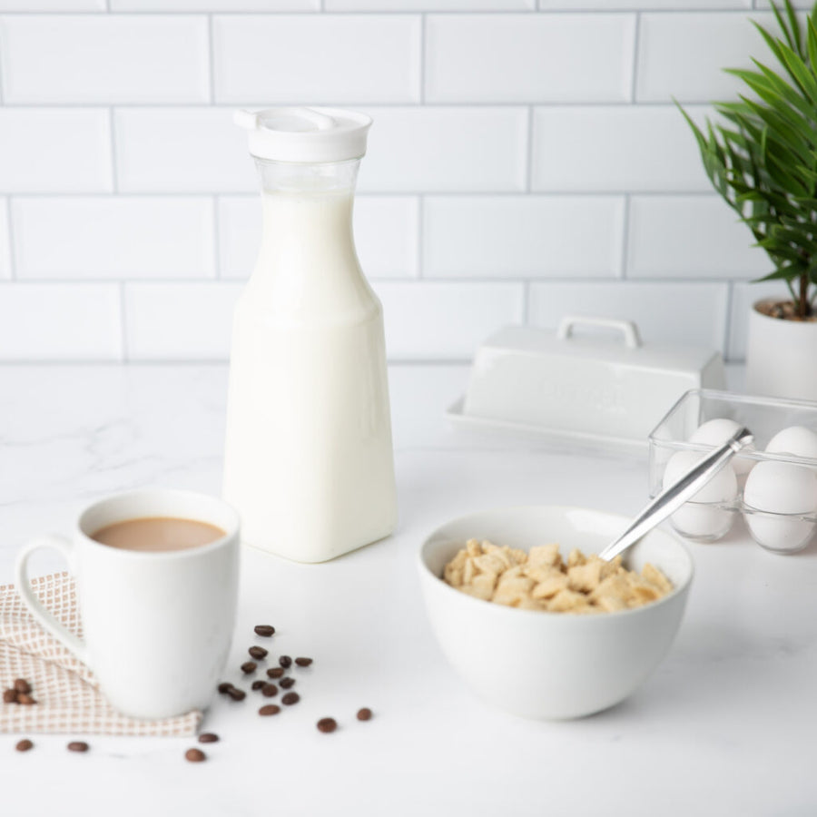 Square Pitcher With White Lid 34 oz filled with milk on a breakfast counter - The Closeout Connection 